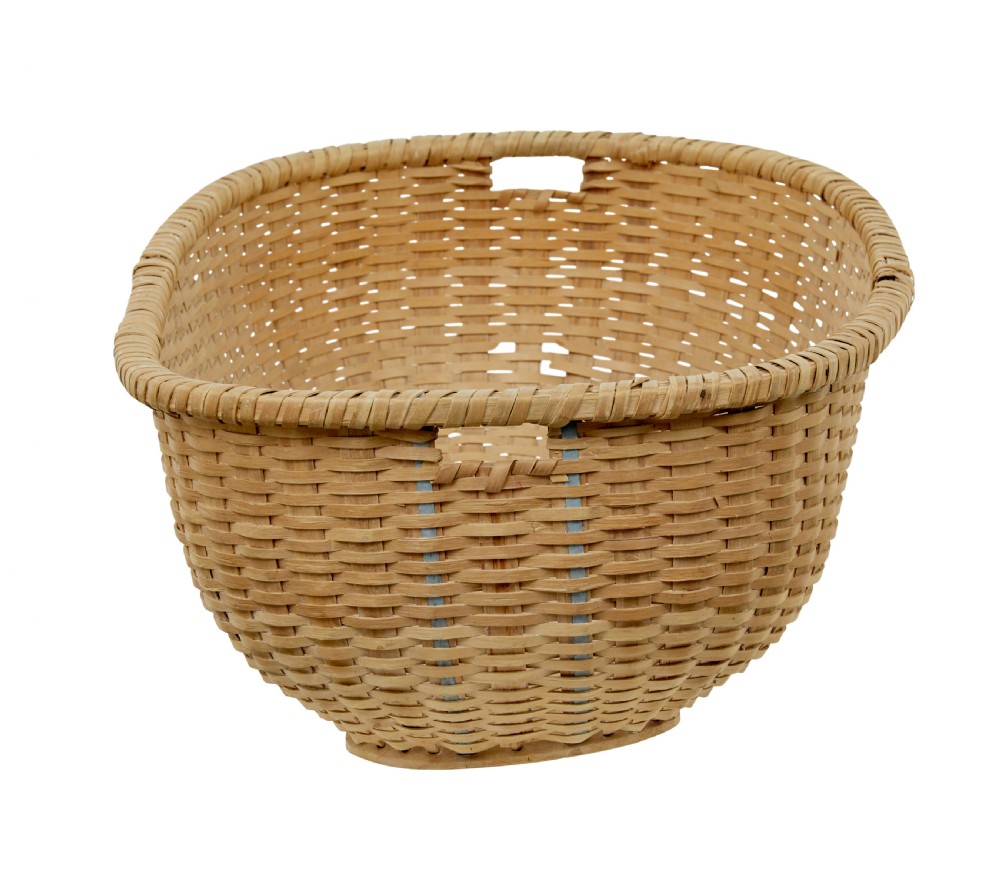 A large oval hand-woven pine basket with integrated handles and a reinforced wooden base. View III