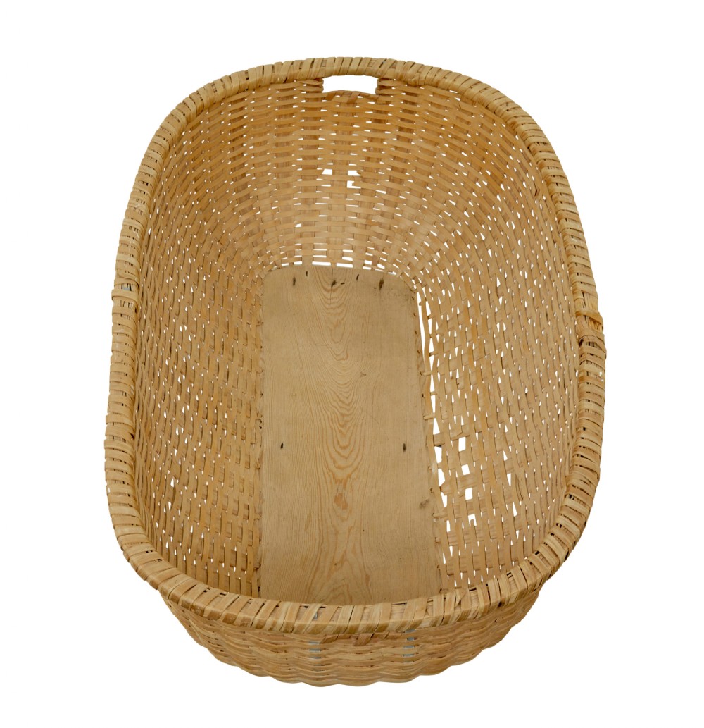 A large oval hand-woven pine basket with integrated handles and a reinforced wooden base. View VI