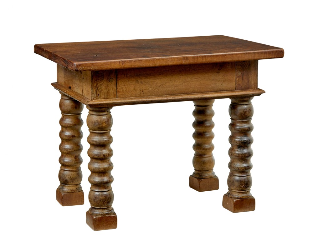 A 19th-century Dutch oak side table featuring a rectangular top and four thick turned legs with square block feet.
