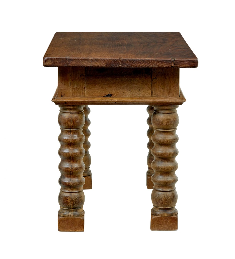 A 19th-century Dutch oak side table featuring a rectangular top and four thick turned legs with square block feet. View V