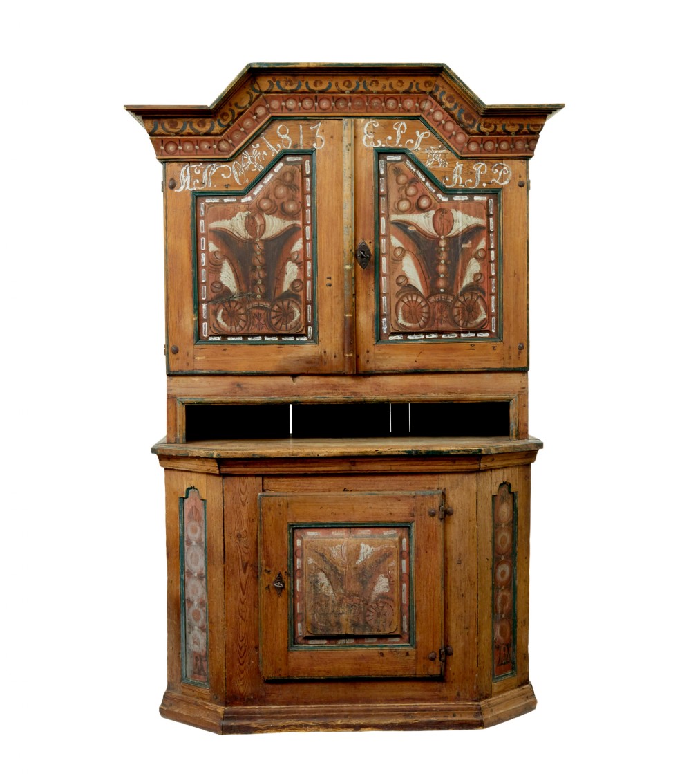 An early nineteenth-century Swedish painted pine cupboard featuring a shaped upper section with painted panel doors dated 1813 above an open shelf and lower cabinet. View II