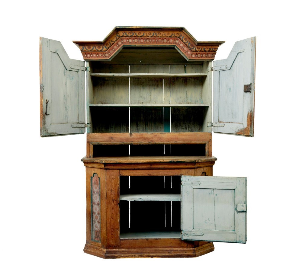 An early nineteenth-century Swedish painted pine cupboard featuring a shaped upper section with painted panel doors dated 1813 above an open shelf and lower cabinet. View III