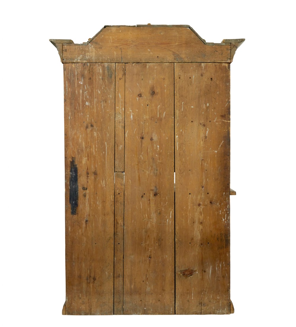 An early nineteenth-century Swedish painted pine cupboard featuring a shaped upper section with painted panel doors dated 1813 above an open shelf and lower cabinet. View V