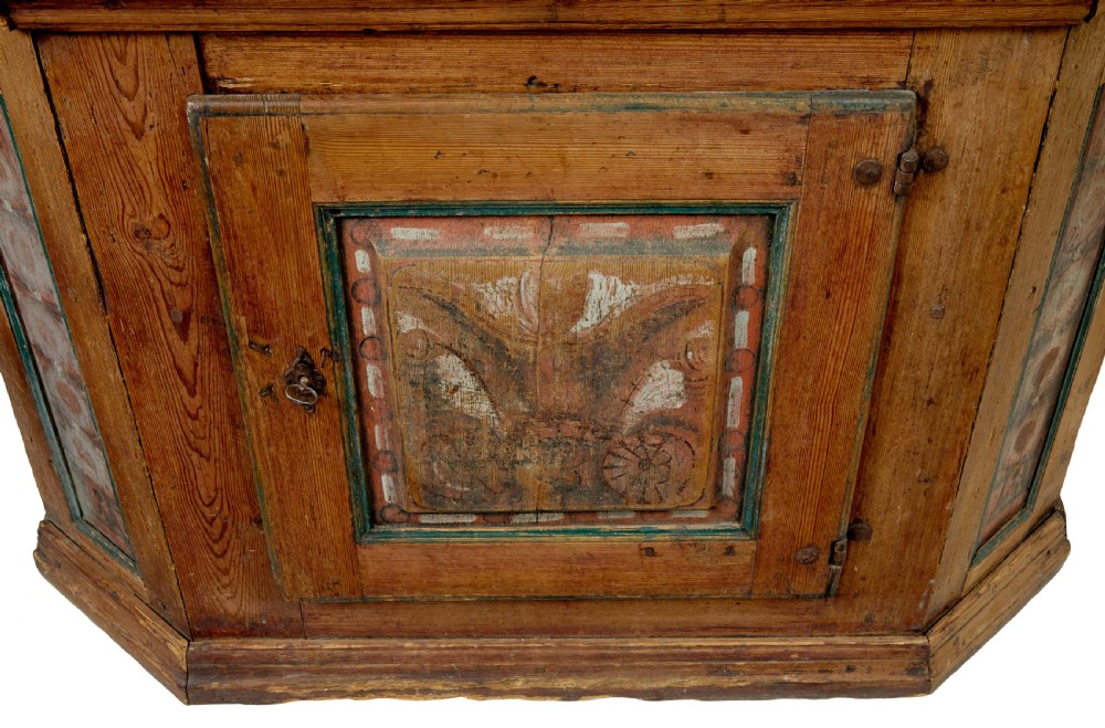 An early nineteenth-century Swedish painted pine cupboard featuring a shaped upper section with painted panel doors dated 1813 above an open shelf and lower cabinet. View XIII