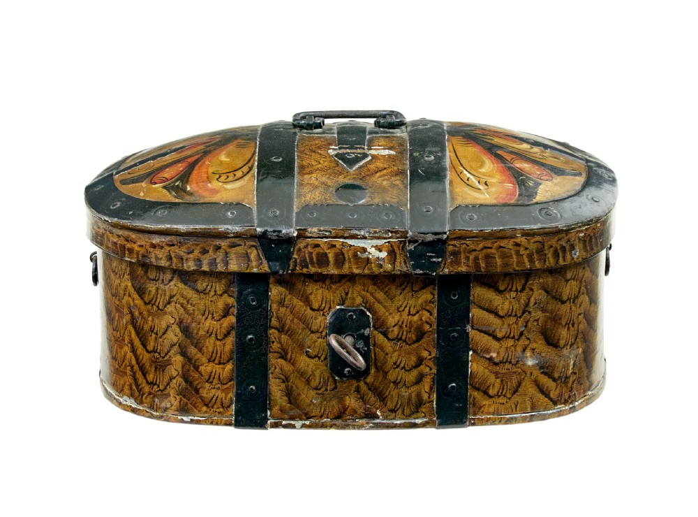 An oval 19th-century Scandinavian painted wooden box featuring black iron straps, a top metal handle, comb-painted sides, and hand-painted floral motifs on the curved lid.