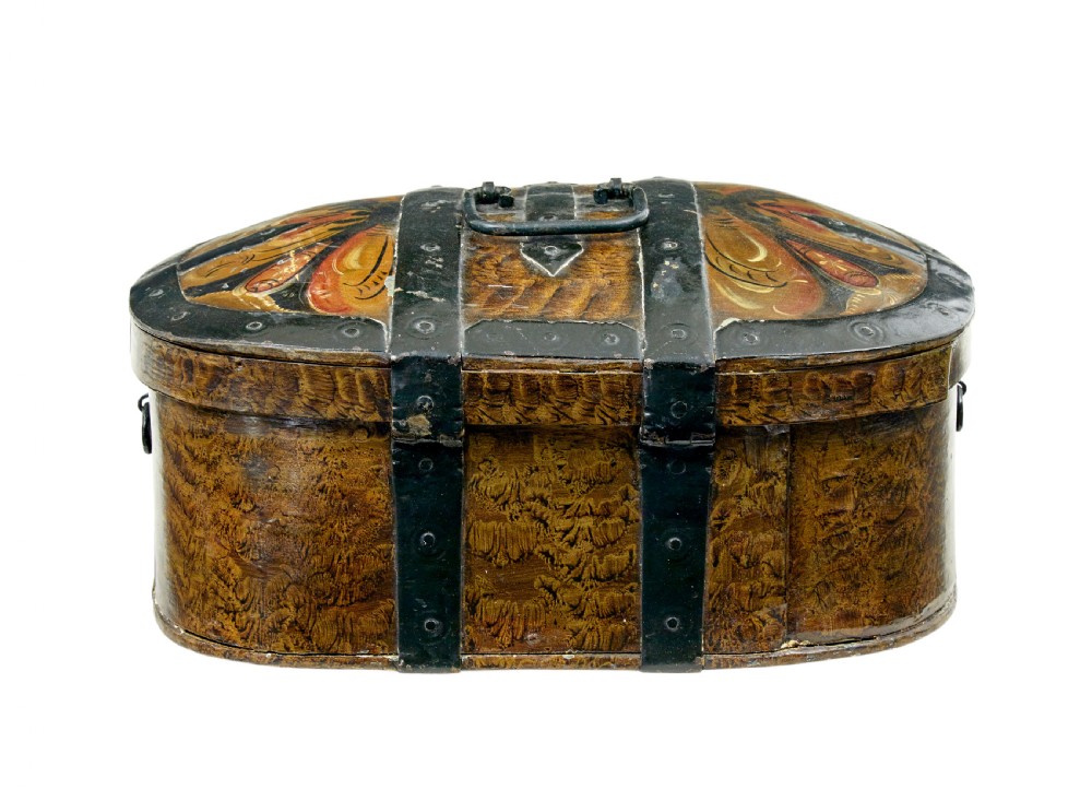 An oval 19th-century Scandinavian painted wooden box featuring black iron straps, a top metal handle, comb-painted sides, and hand-painted floral motifs on the curved lid. View II