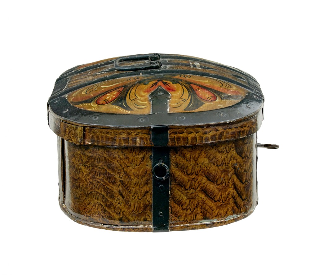 An oval 19th-century Scandinavian painted wooden box featuring black iron straps, a top metal handle, comb-painted sides, and hand-painted floral motifs on the curved lid. View III