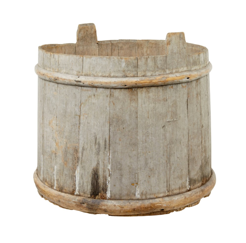 A large round 19th-century Scandinavian pine storage barrel featuring vertical stave timber construction and thick wooden binding hoops around the top and bottom. View V
