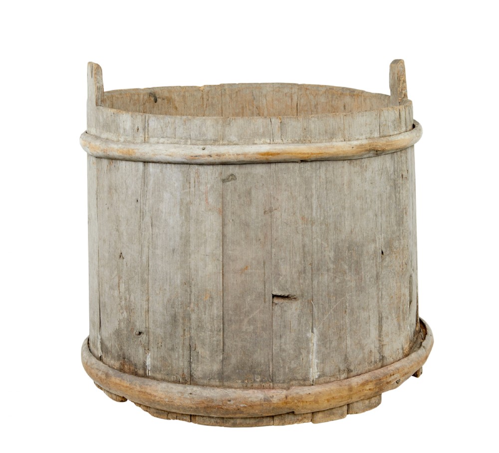 A large round 19th-century Scandinavian pine storage barrel featuring vertical stave timber construction and thick wooden binding hoops around the top and bottom. View VII