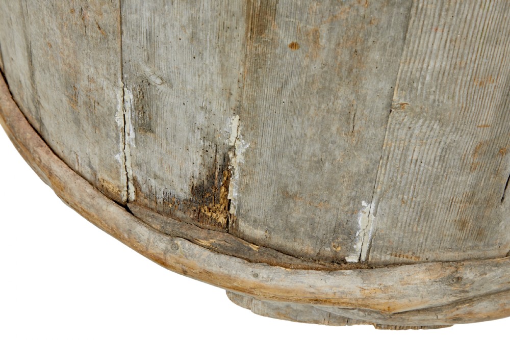 A large round 19th-century Scandinavian pine storage barrel featuring vertical stave timber construction and thick wooden binding hoops around the top and bottom. View X
