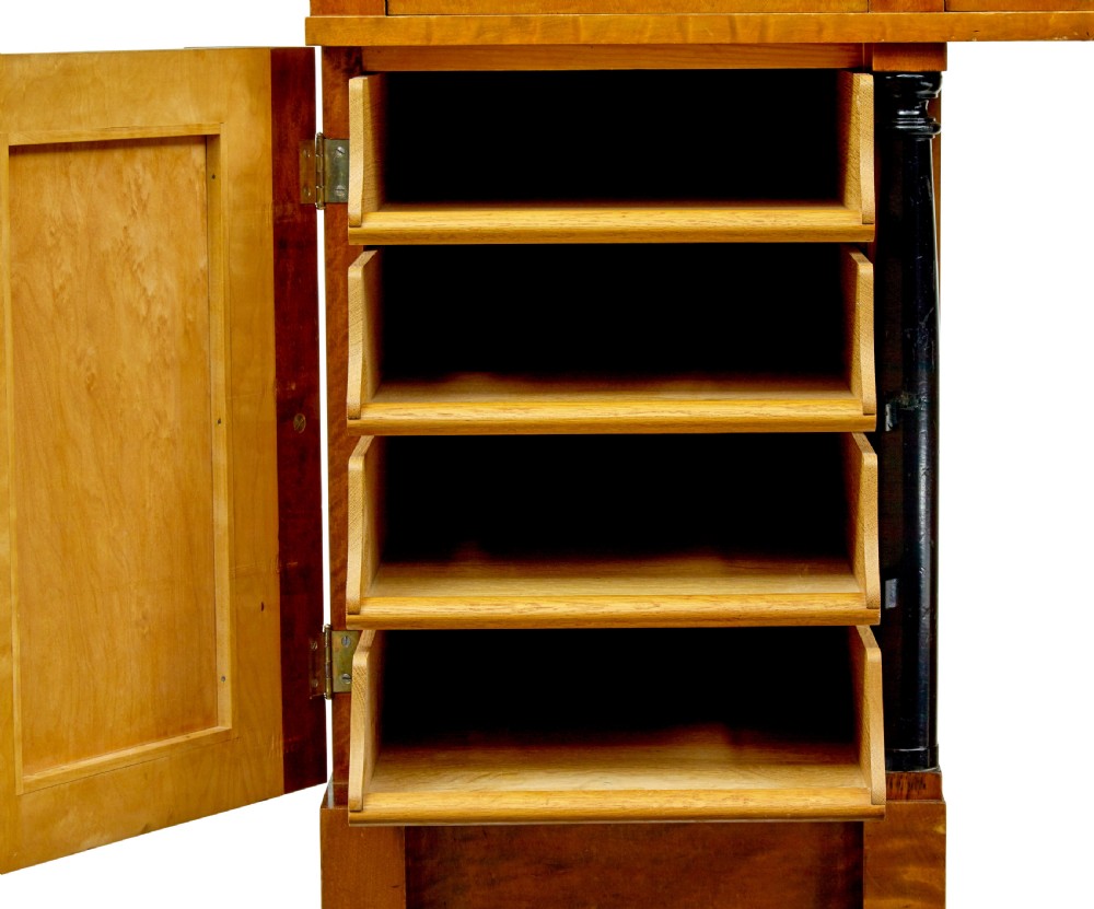 A Swedish Empire Revival pedestal desk crafted from golden flame birch veneer featuring three frieze drawers, ebonised column accents, and geometric inlaid cabinet doors. View VIII