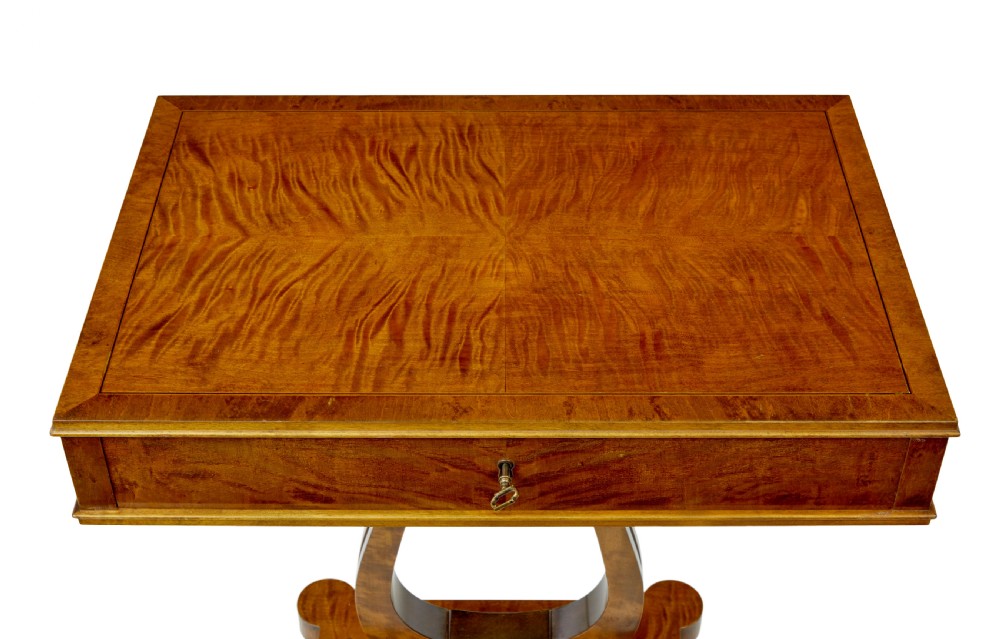 A late nineteenth-century warm golden birch sewing table featuring a single drawer with a brass keyhole, supported by a lyre-shaped pedestal on a plinth base with bun feet. View IV