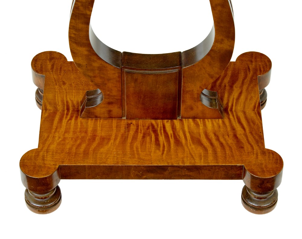 A late nineteenth-century warm golden birch sewing table featuring a single drawer with a brass keyhole, supported by a lyre-shaped pedestal on a plinth base with bun feet. View VI