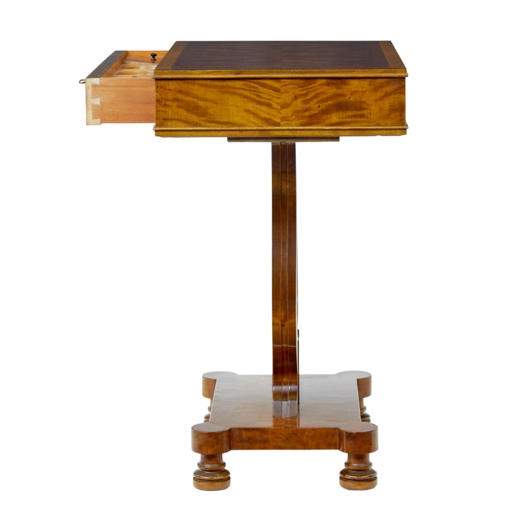 A late nineteenth-century warm golden birch sewing table featuring a single drawer with a brass keyhole, supported by a lyre-shaped pedestal on a plinth base with bun feet. View VIII