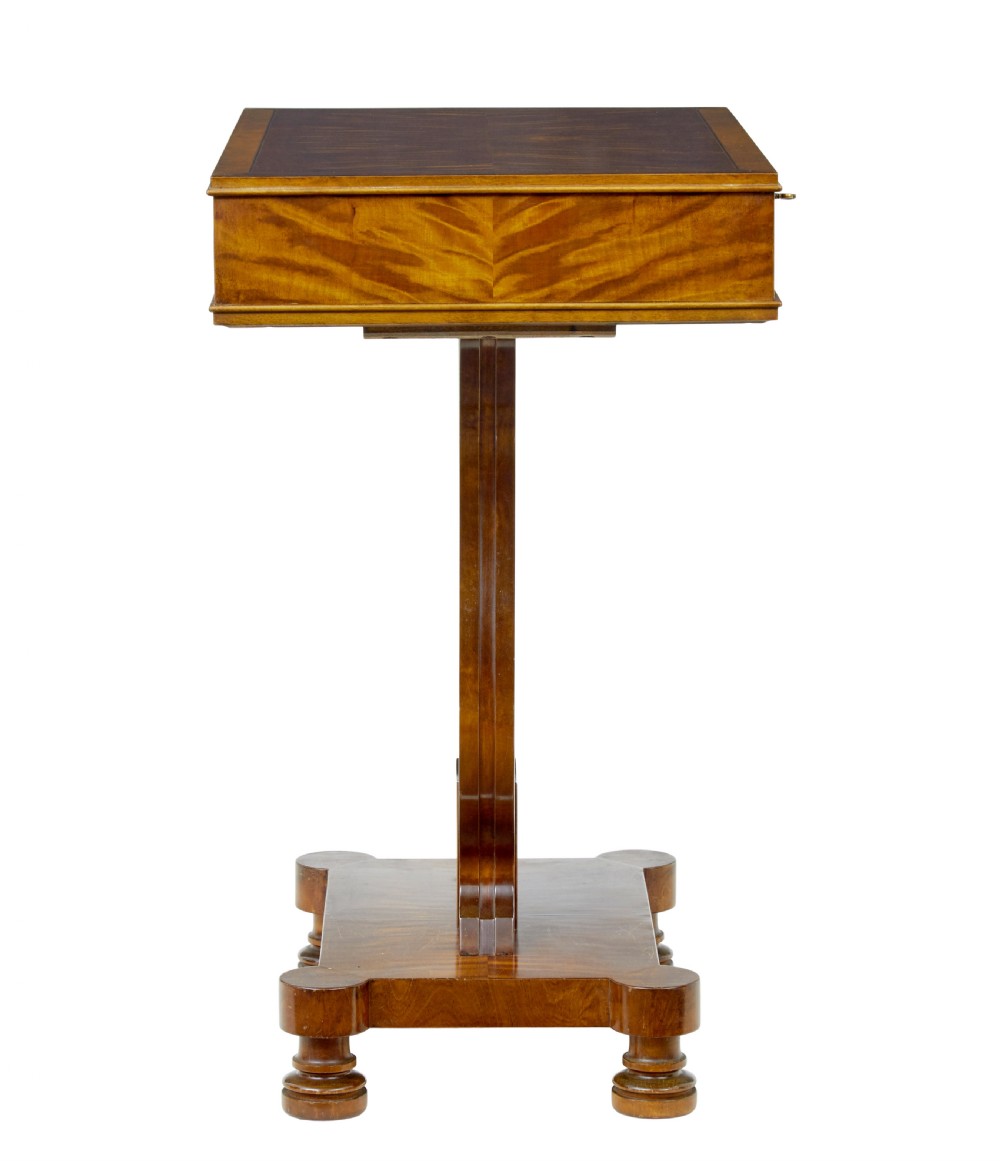 A late nineteenth-century warm golden birch sewing table featuring a single drawer with a brass keyhole, supported by a lyre-shaped pedestal on a plinth base with bun feet. View X