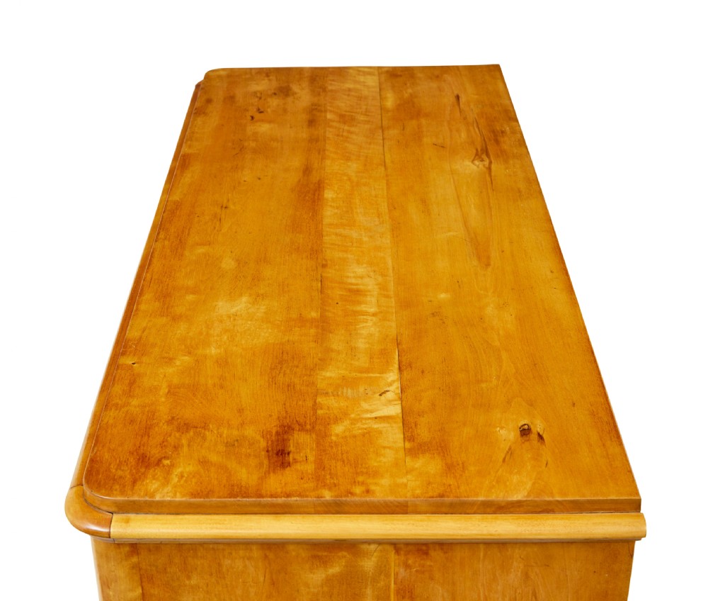 A nineteenth-century Scandinavian chest of drawers crafted from golden birch with four wide drawers and keyhole escutcheons. View III