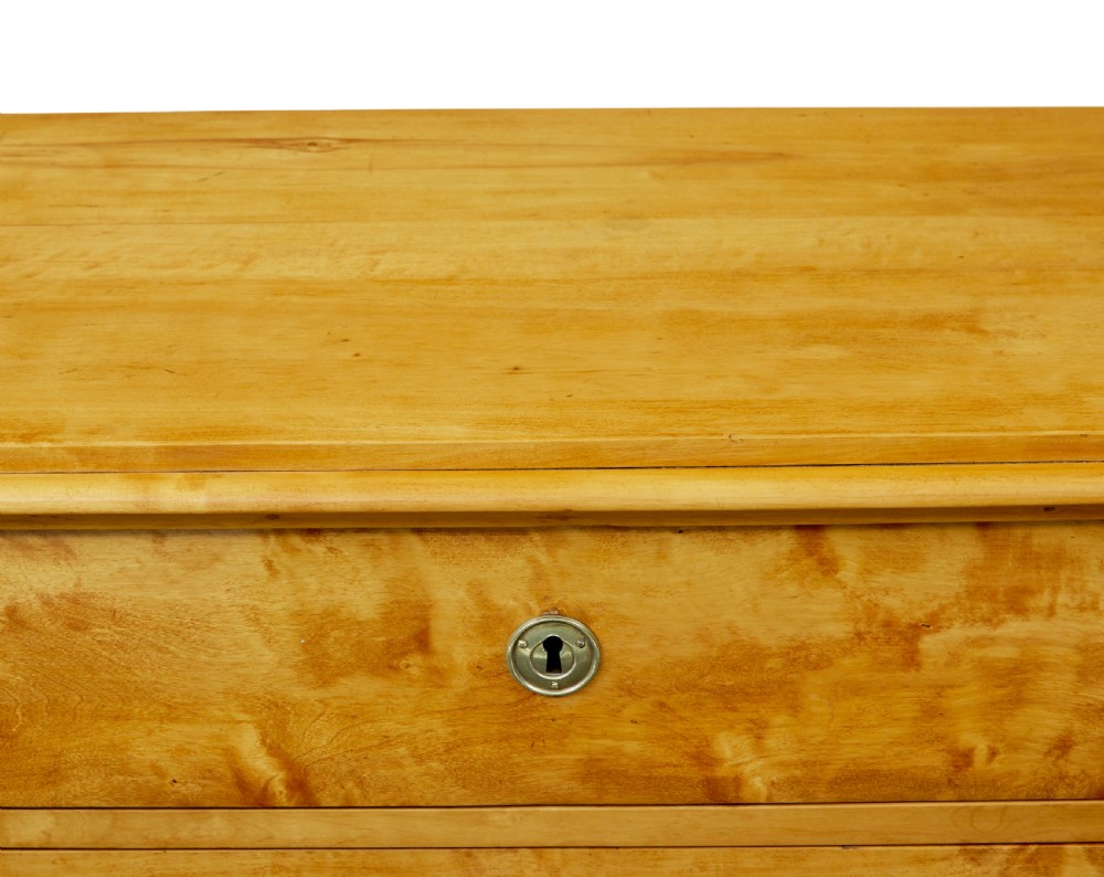 A nineteenth-century Scandinavian chest of drawers crafted from golden birch with four wide drawers and keyhole escutcheons. View IV
