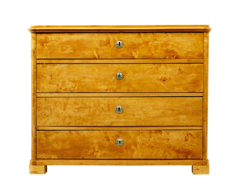 A nineteenth-century Scandinavian chest of drawers crafted from golden birch with four wide drawers and keyhole escutcheons. View V
