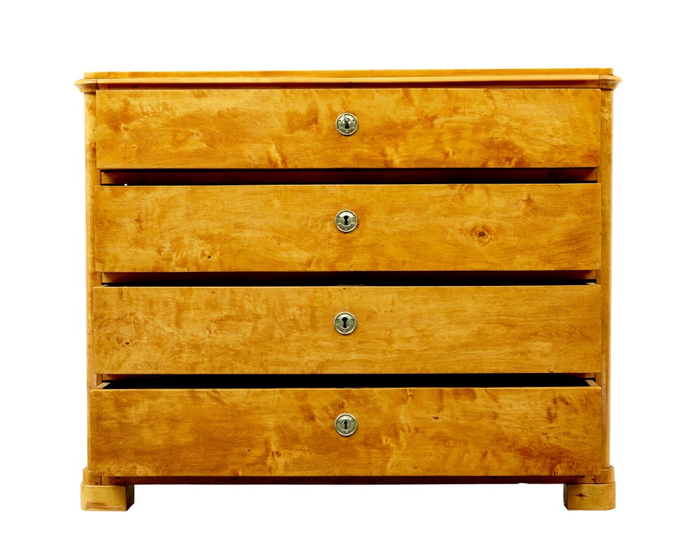 A nineteenth-century Scandinavian chest of drawers crafted from golden birch with four wide drawers and keyhole escutcheons. View VI