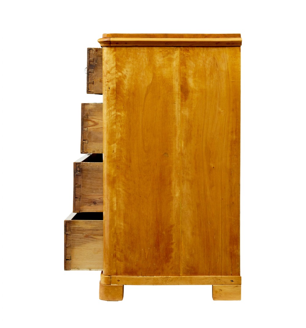 A nineteenth-century Scandinavian chest of drawers crafted from golden birch with four wide drawers and keyhole escutcheons. View VII