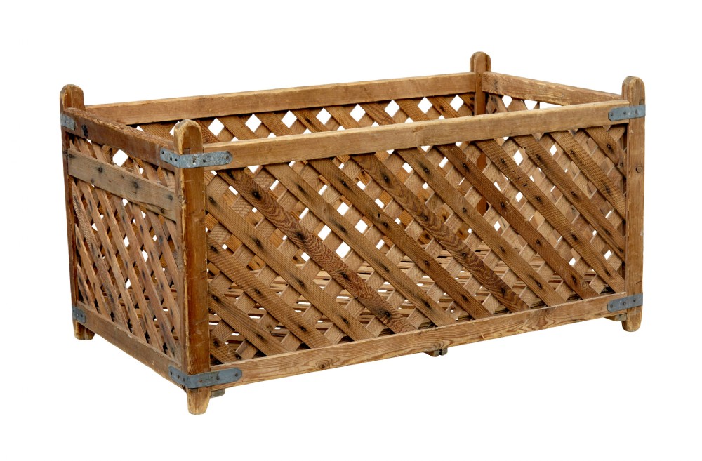 A rectangular 19th-century Scandinavian pine log basket with diagonal lattice side panels and iron corner braces. View II