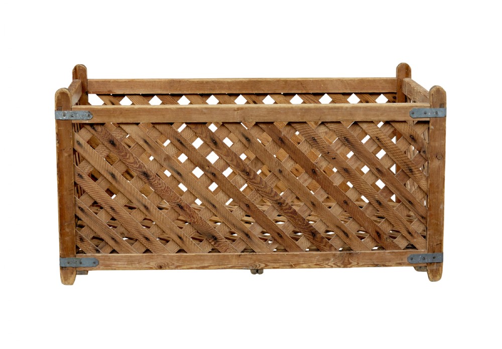 A rectangular 19th-century Scandinavian pine log basket with diagonal lattice side panels and iron corner braces. View III