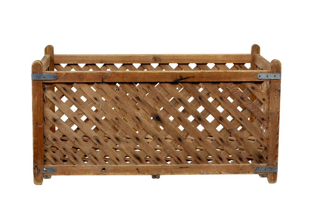 A rectangular 19th-century Scandinavian pine log basket with diagonal lattice side panels and iron corner braces. View V