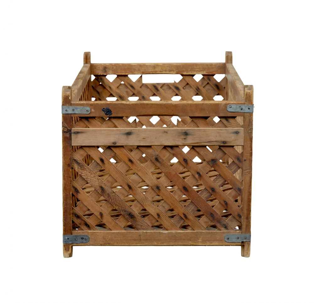 A rectangular 19th-century Scandinavian pine log basket with diagonal lattice side panels and iron corner braces. View VI