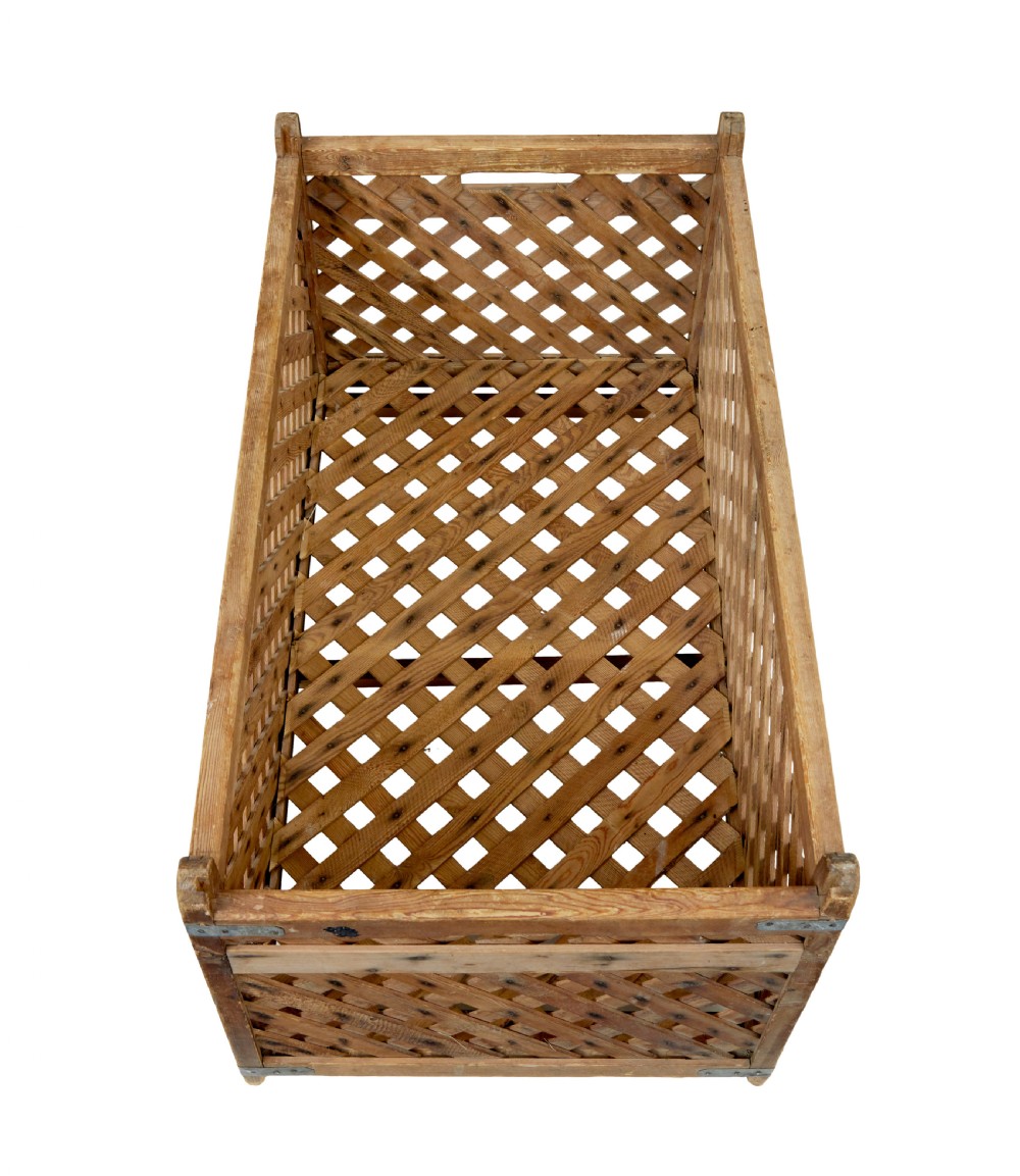 A rectangular 19th-century Scandinavian pine log basket with diagonal lattice side panels and iron corner braces. View VII