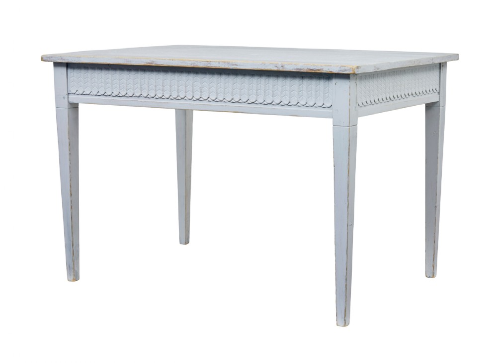 A late 19th-century Swedish painted pine table featuring a rectangular top, a carved patterned apron, and four square tapered legs.