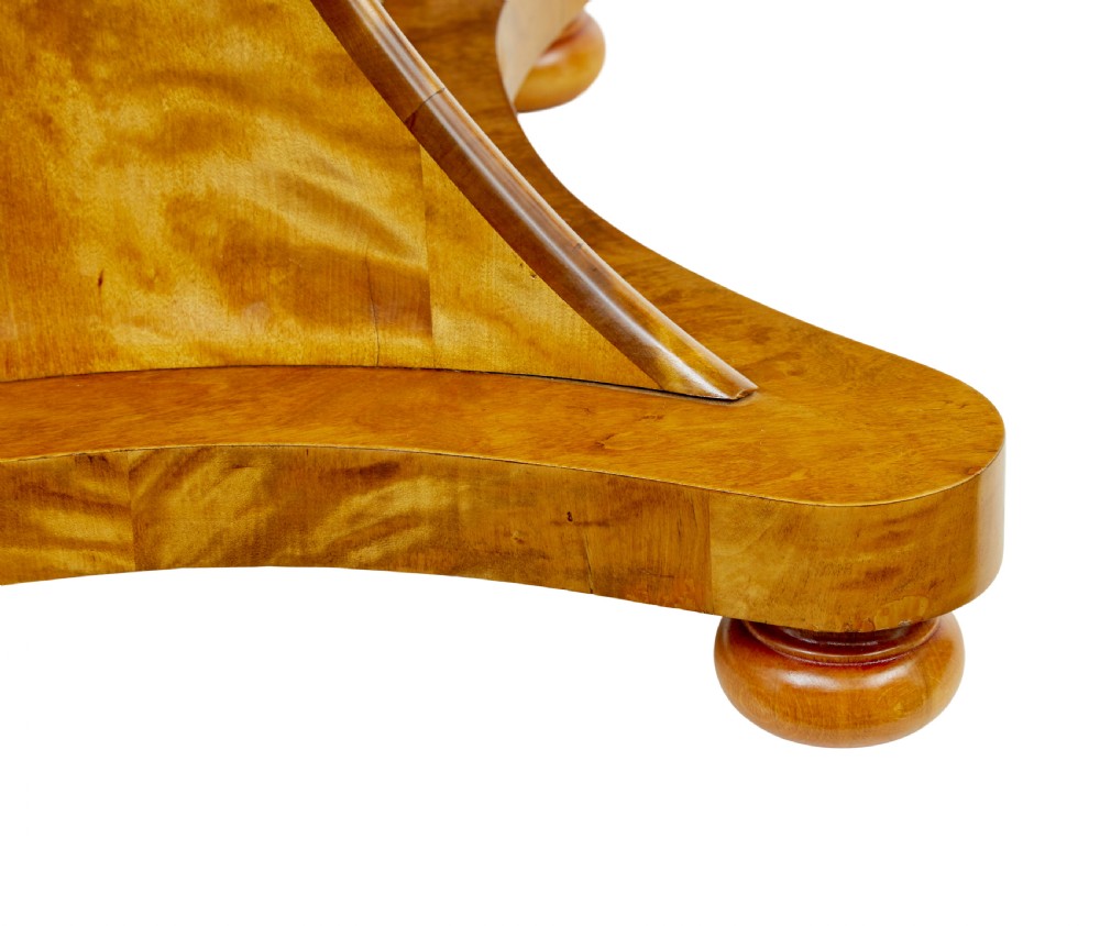 A circular golden flame birch centre table featuring a starburst-patterned veneer top, decorative inlaid rim border, sweeping concave pedestal stem, and quadform base with bun feet. View VIII
