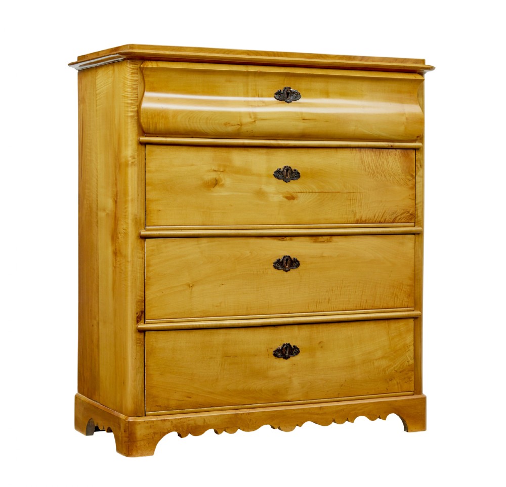 A 19th-century Swedish chest of drawers constructed from honey-toned flame birch with four drawers, keyhole escutcheons, and a scalloped base apron.