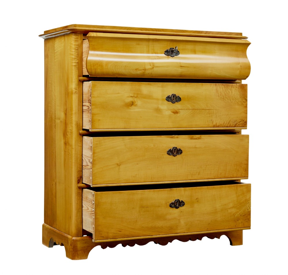A 19th-century Swedish chest of drawers constructed from honey-toned flame birch with four drawers, keyhole escutcheons, and a scalloped base apron. View V