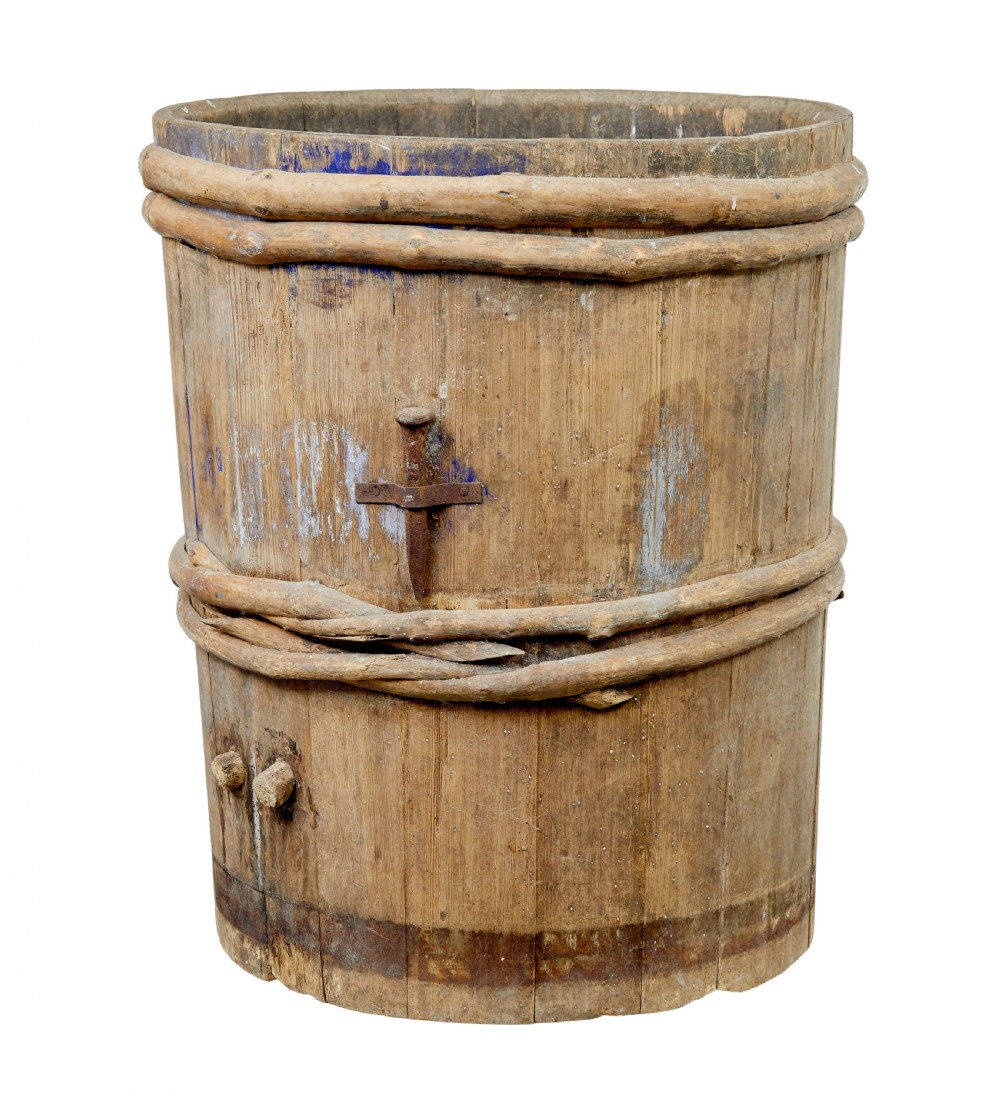 A 19th-century cylindrical Swedish pine barrel featuring hand-bound branch hoops, iron fittings, and remnants of blue paint.