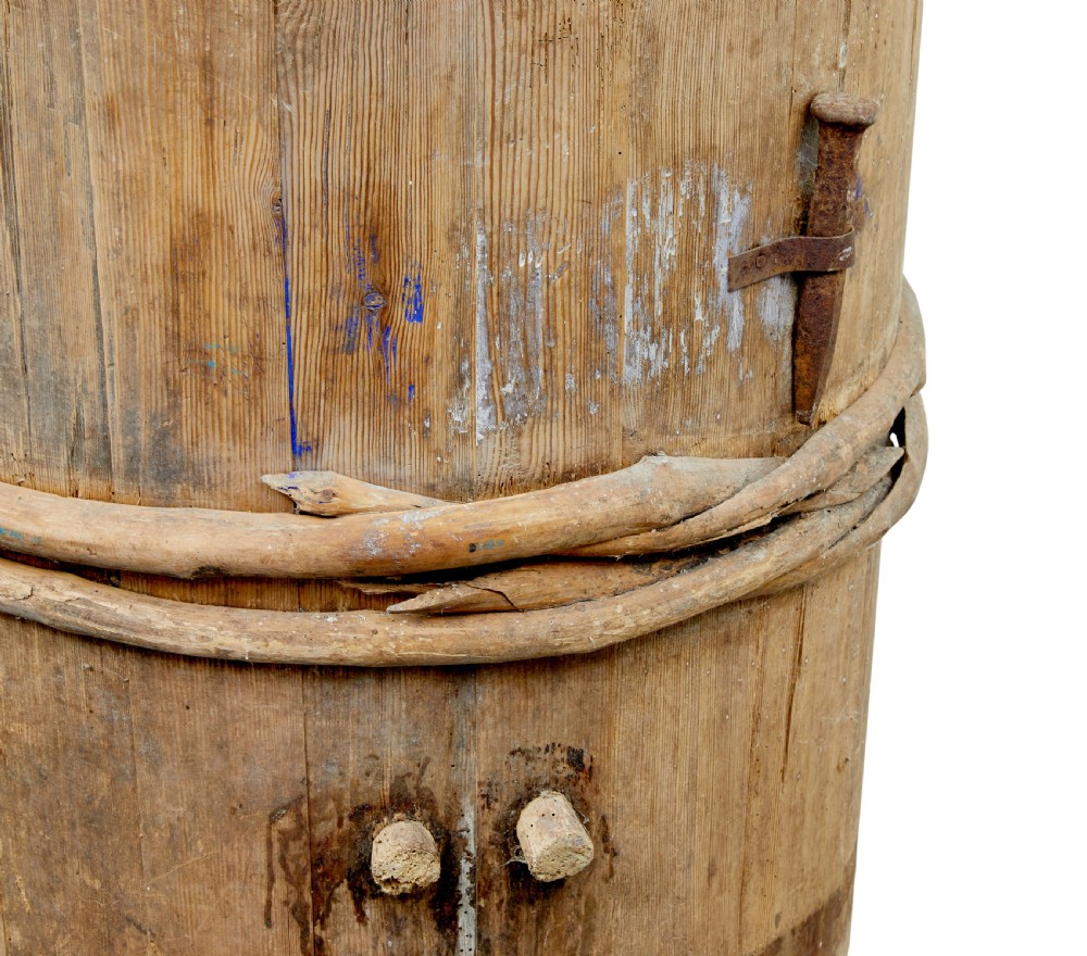 A 19th-century cylindrical Swedish pine barrel featuring hand-bound branch hoops, iron fittings, and remnants of blue paint. View VI