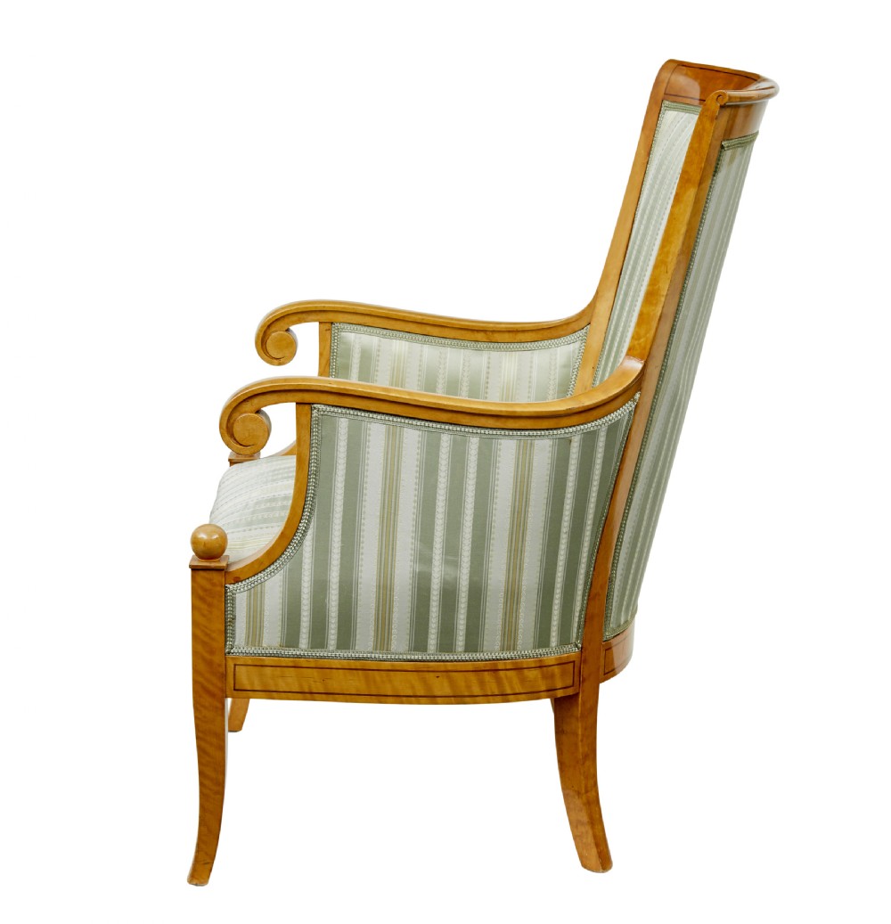 A set of four early 20th-century Karl Johan style birch armchairs featuring scroll arms and green striped upholstery. View IV