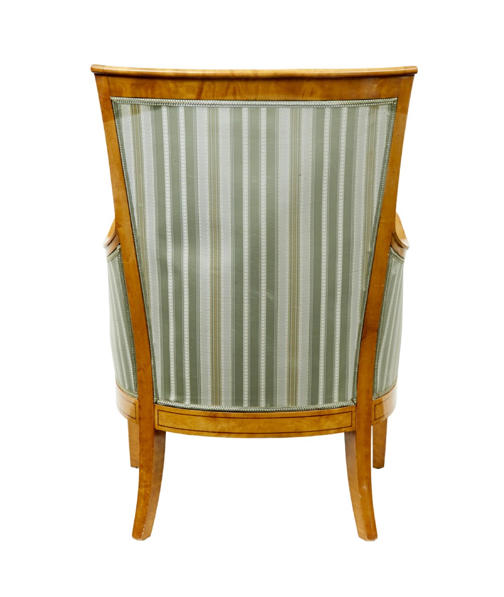 A set of four early 20th-century Karl Johan style birch armchairs featuring scroll arms and green striped upholstery. View V