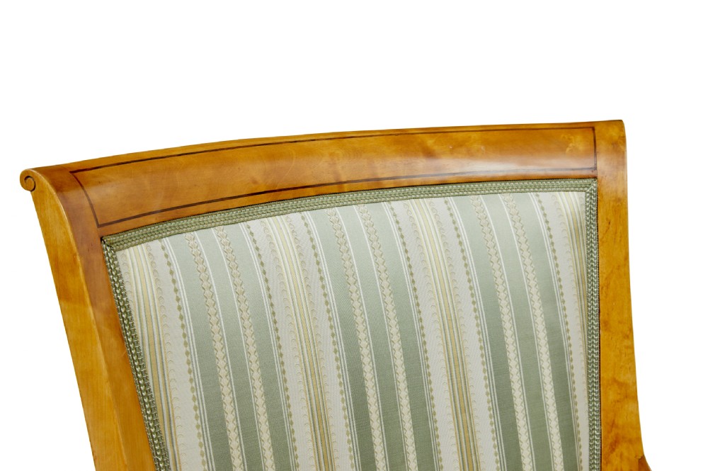 A set of four early 20th-century Karl Johan style birch armchairs featuring scroll arms and green striped upholstery. View VII