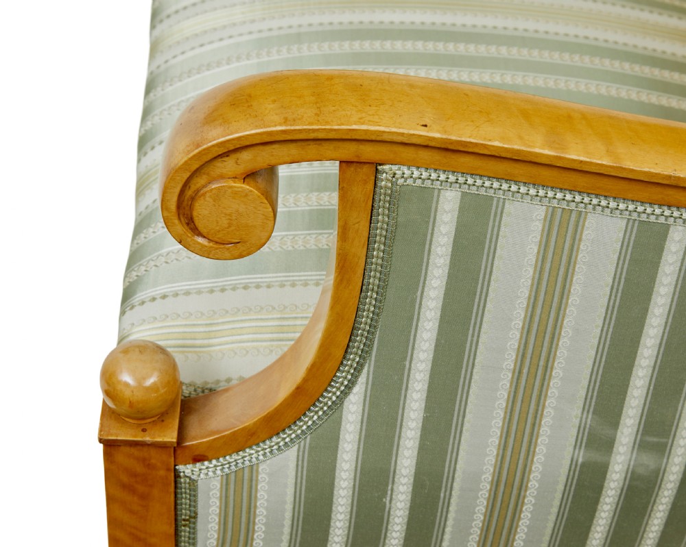 A set of four early 20th-century Karl Johan style birch armchairs featuring scroll arms and green striped upholstery. View IX