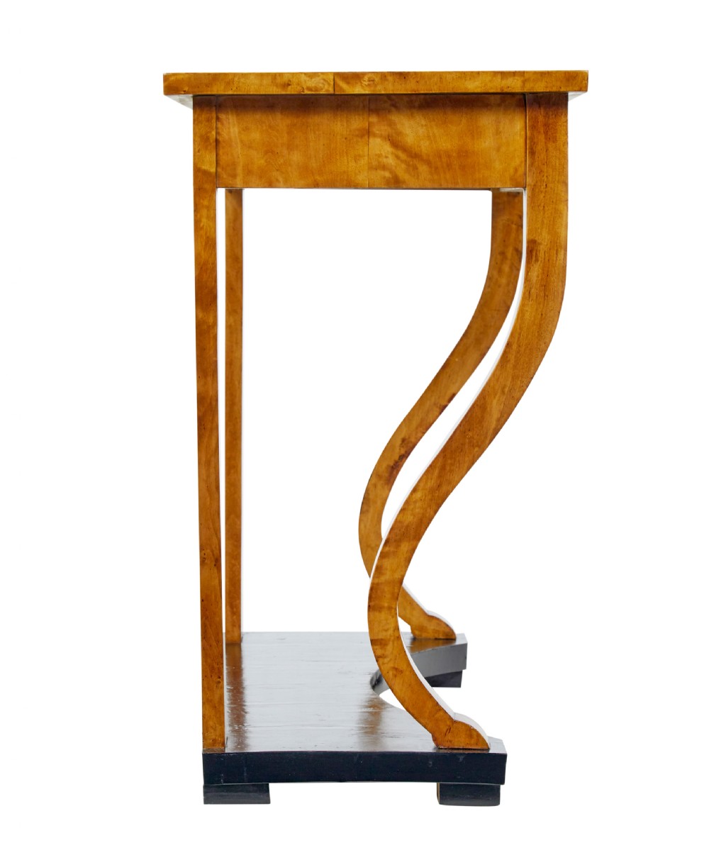 A nineteenth-century Empire Revival console table crafted from figured burr birch with curved leg supports and an ebonised plinth base. View III