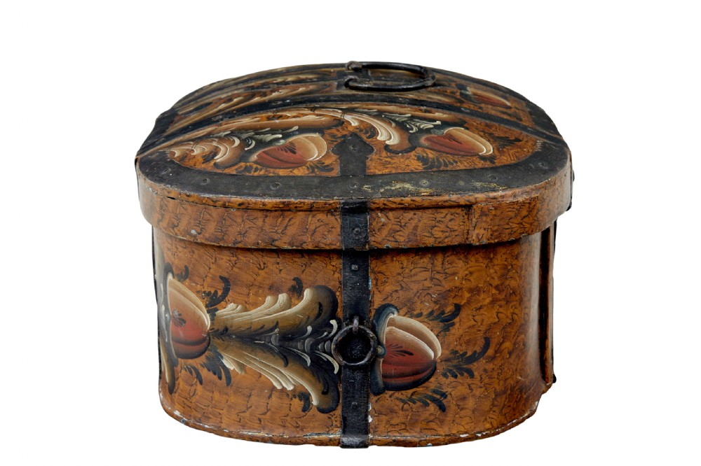 A 19th-century oval Scandinavian wooden box painted in warm ochre with dark floral scrollwork and fitted with black iron banding. View IV
