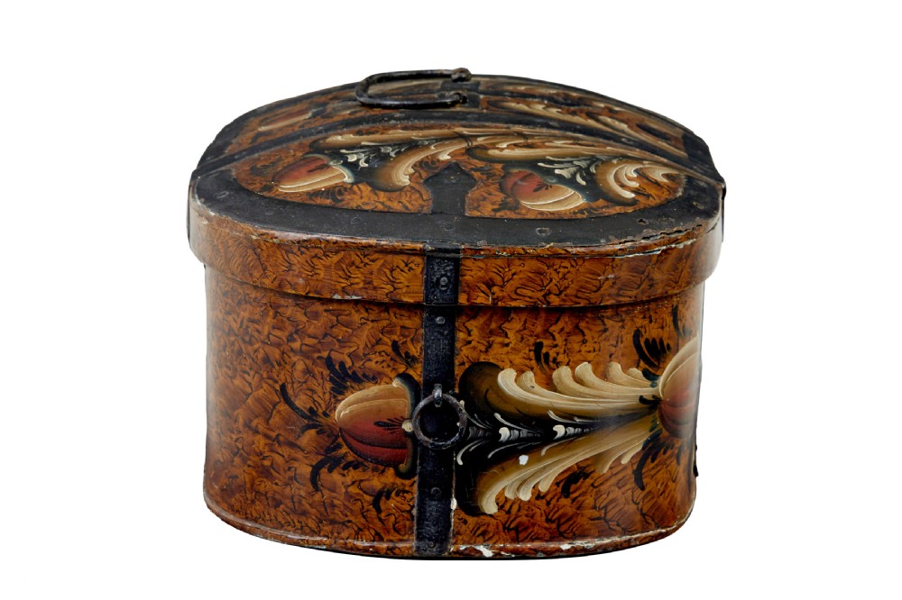 A 19th-century oval Scandinavian wooden box painted in warm ochre with dark floral scrollwork and fitted with black iron banding. View VI