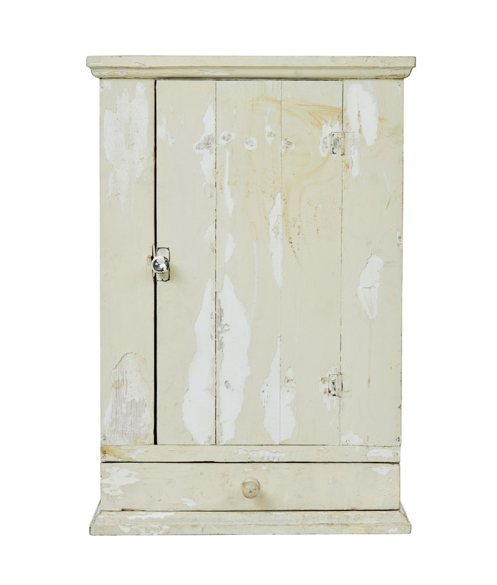 A 19th-century Scandinavian pine wall cupboard with a distressed cream painted finish, a single panelled door, and one lower drawer. View III
