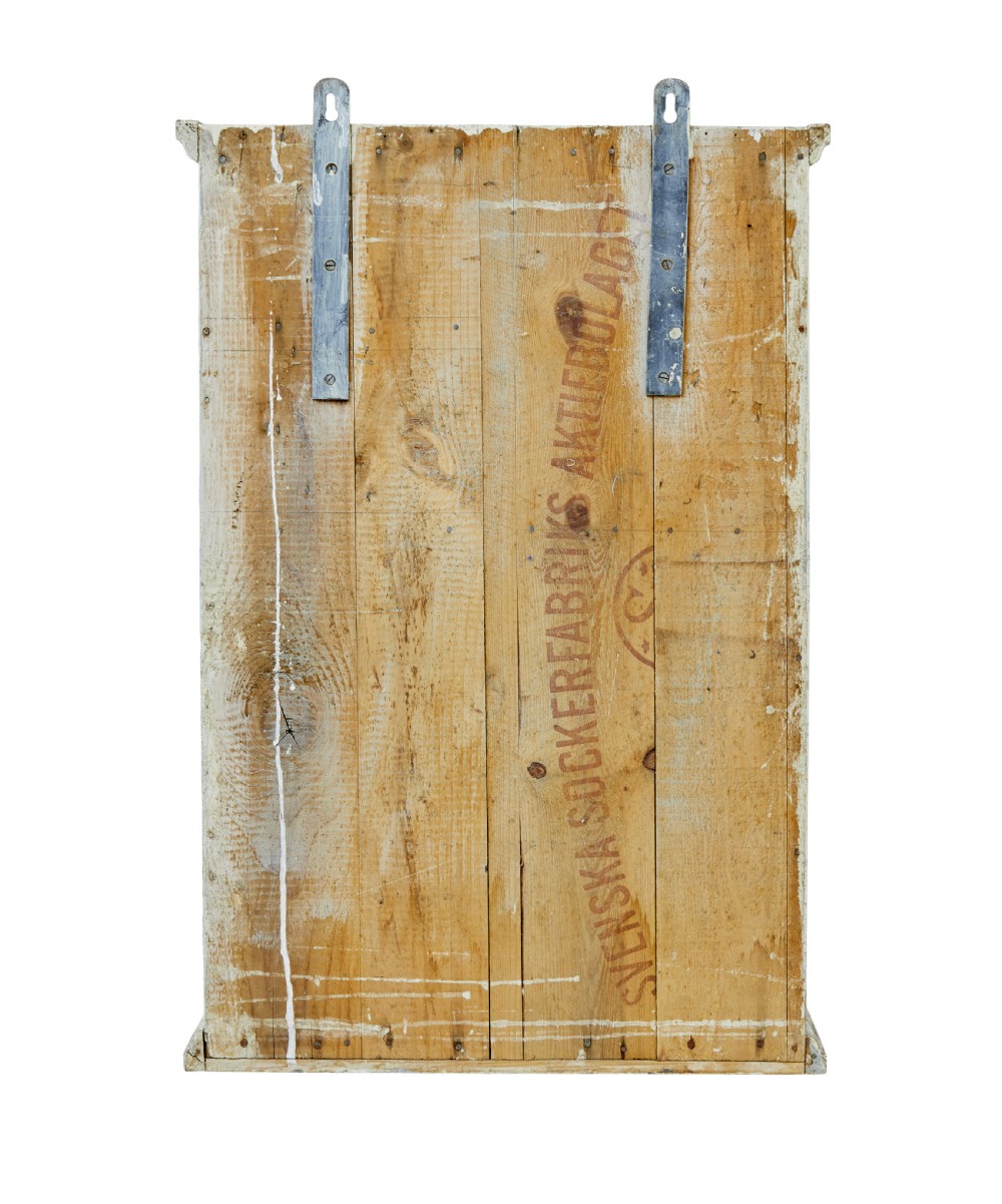 A 19th-century Scandinavian pine wall cupboard with a distressed cream painted finish, a single panelled door, and one lower drawer. View VI