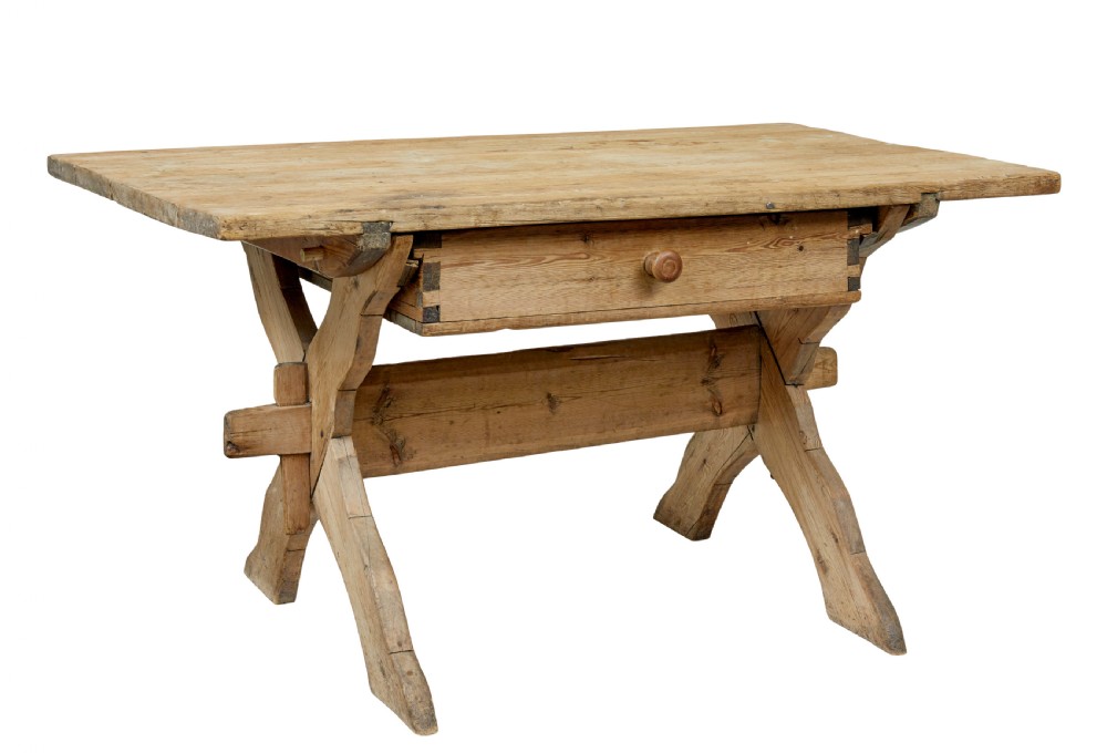 A 19th-century Swedish pine kitchen table featuring an X-frame base with pegged stretcher joints and a single central drawer.