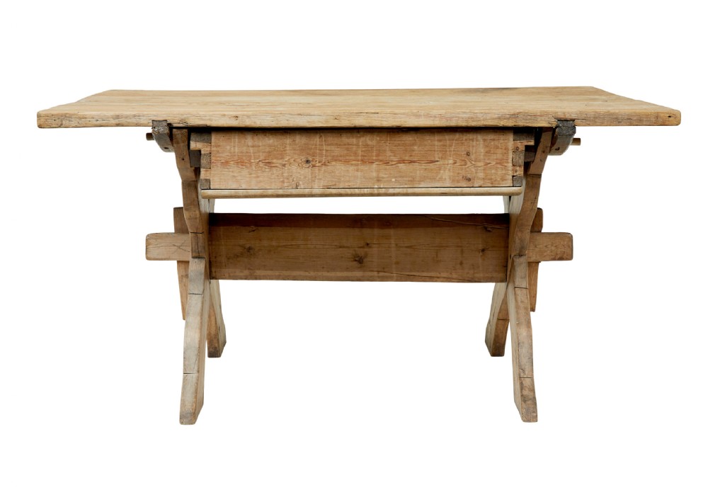 A 19th-century Swedish pine kitchen table featuring an X-frame base with pegged stretcher joints and a single central drawer. View V