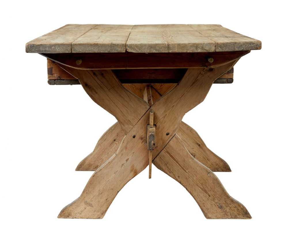 A 19th-century Swedish pine kitchen table featuring an X-frame base with pegged stretcher joints and a single central drawer. View VI