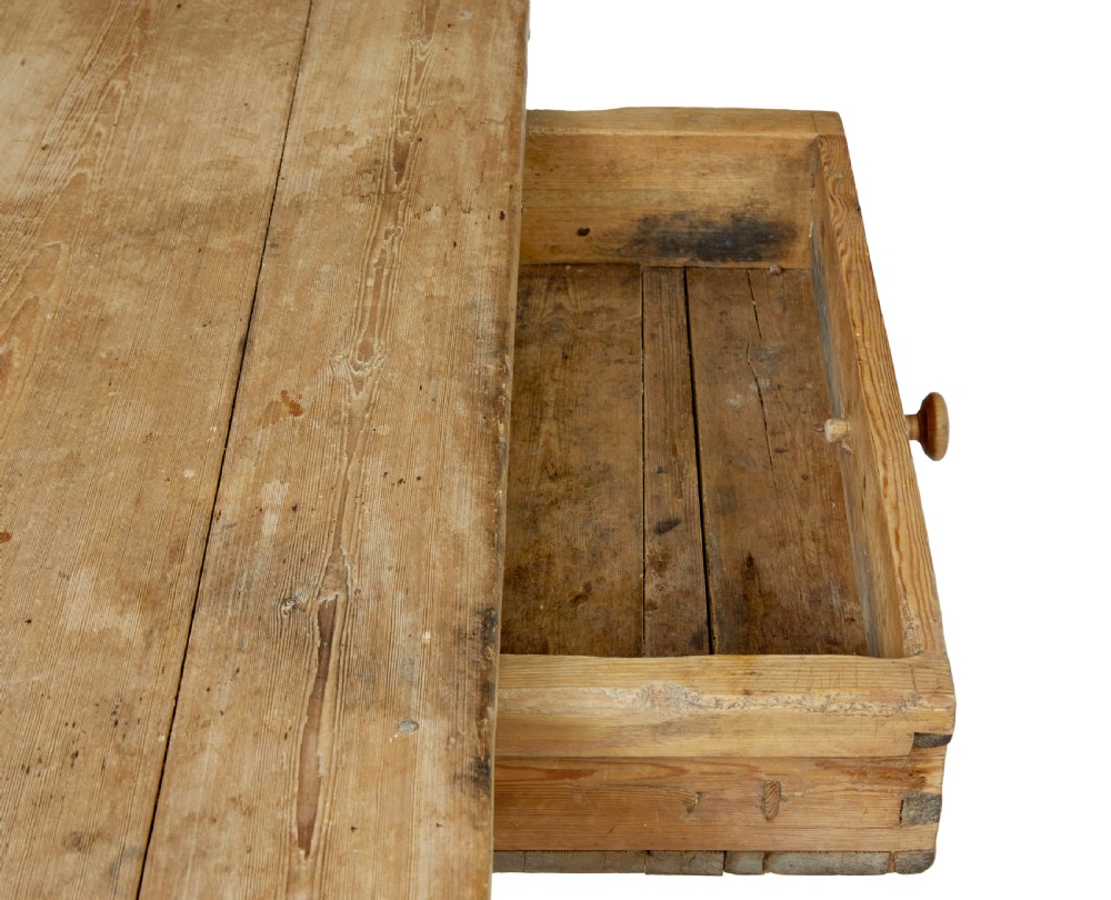 A 19th-century Swedish pine kitchen table featuring an X-frame base with pegged stretcher joints and a single central drawer. View VIII
