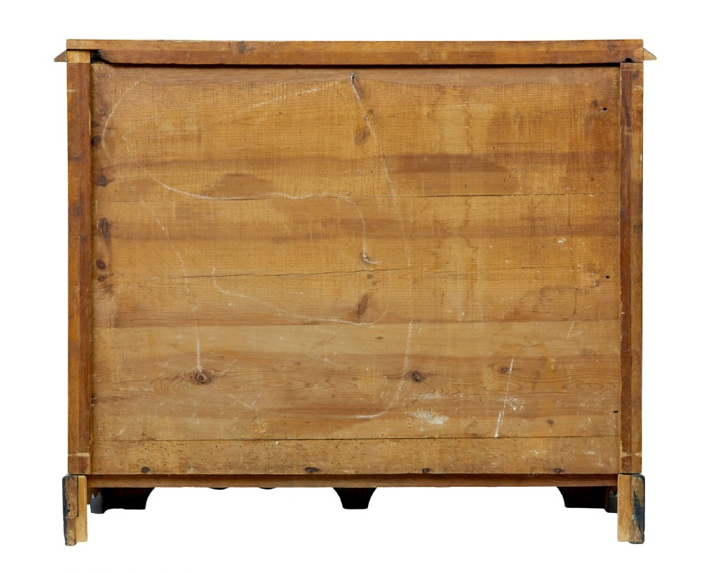 A 19th-century Swedish Empire Revival birch chest of drawers featuring four graduated drawers with metal handles, keyhole escutcheons, and a dark ebonised plinth base. View V
