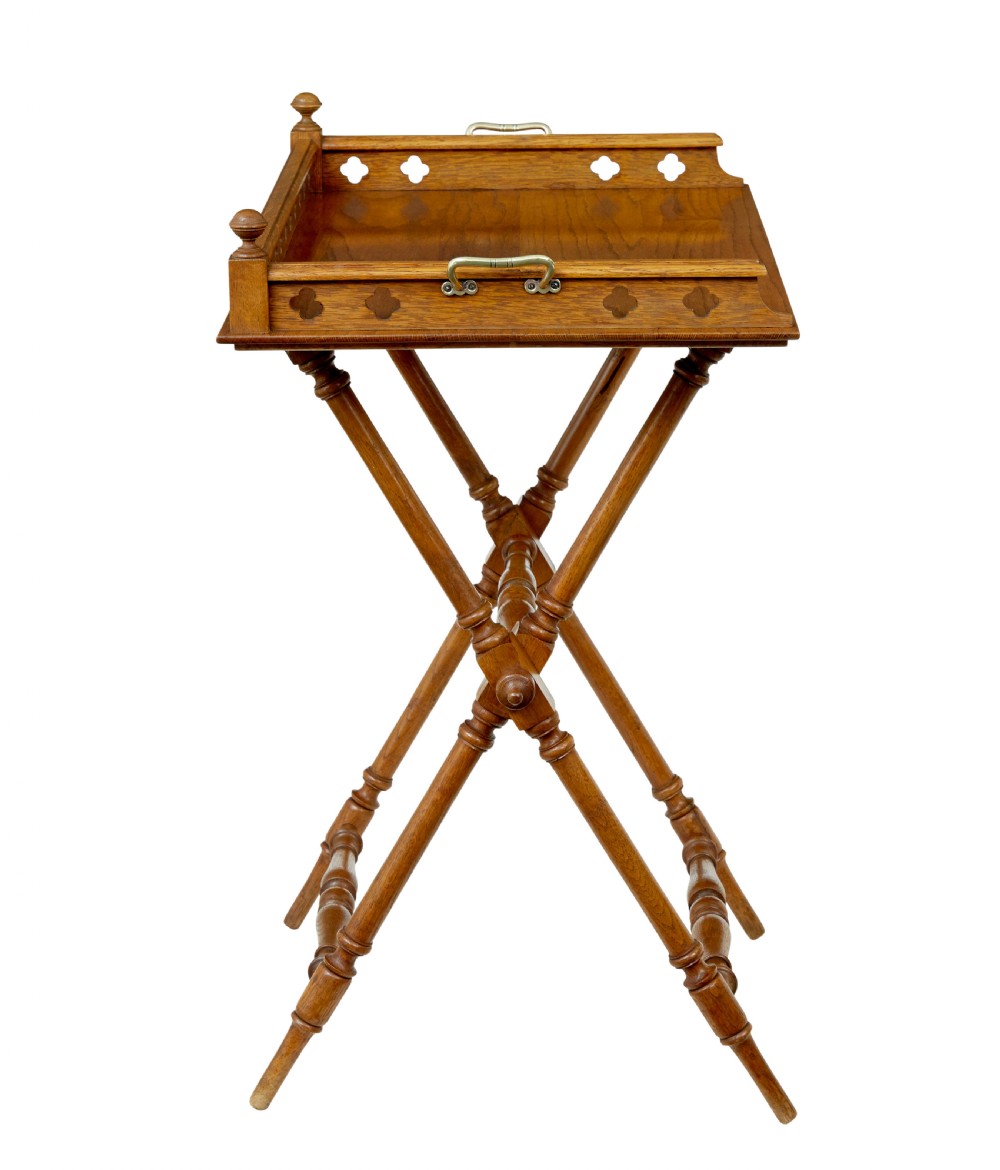 A 19th-century oak butlers tray featuring a trefoil pierced gallery border and brass handles resting on a folding X-frame stand. View VIII